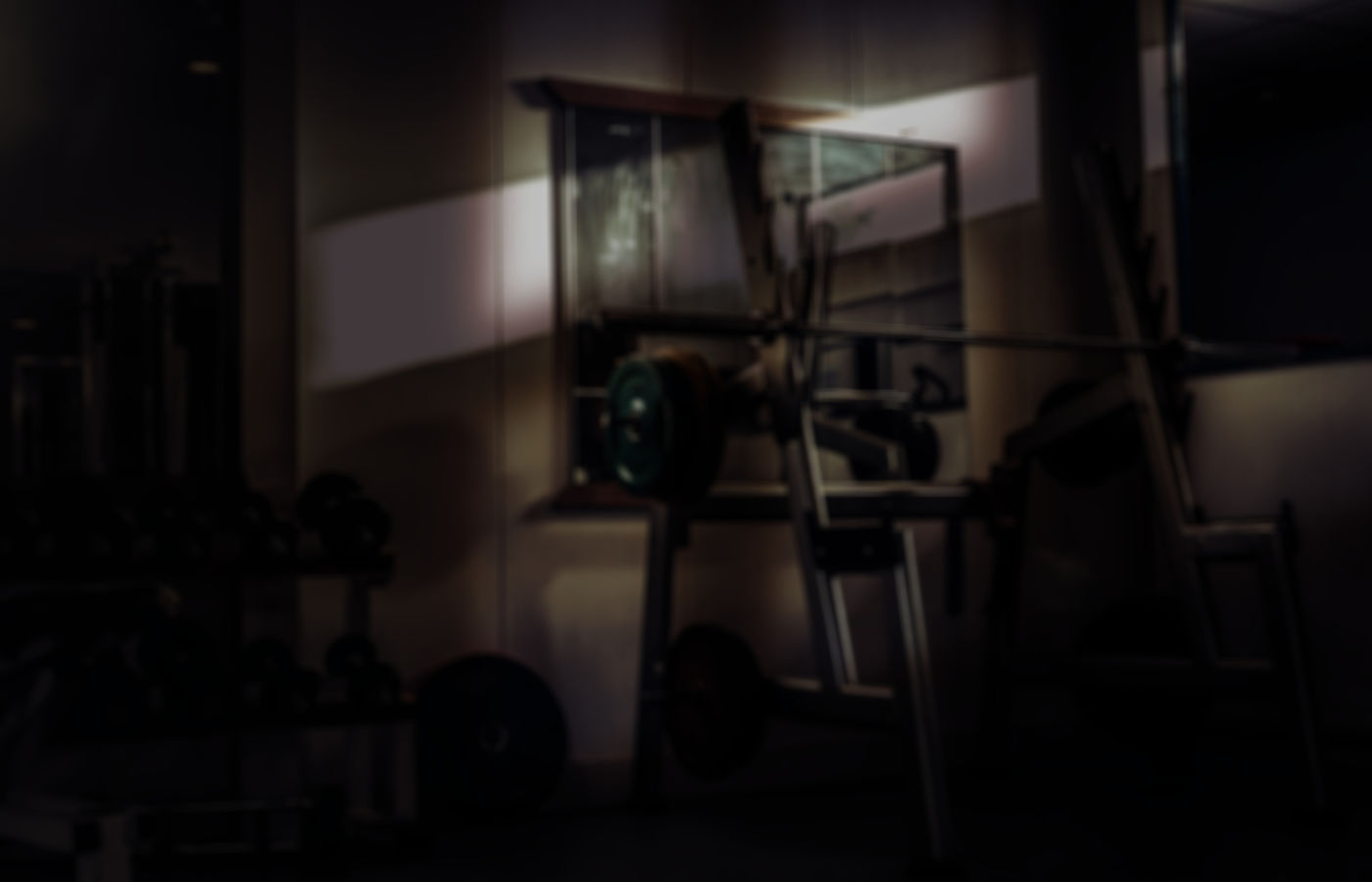 Strength training equipment in a dark gym